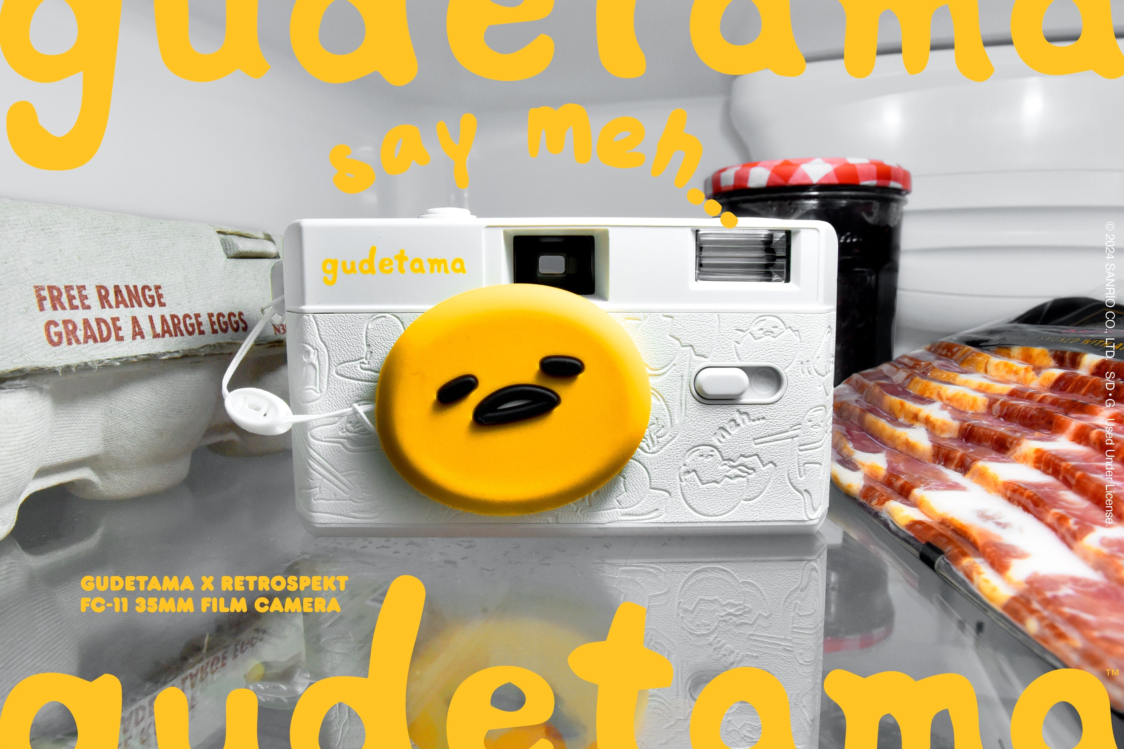 The Gudetama FC-11 35mm Film Camera sitting in a refridgerator surrounded by eggs, bacon and jam.